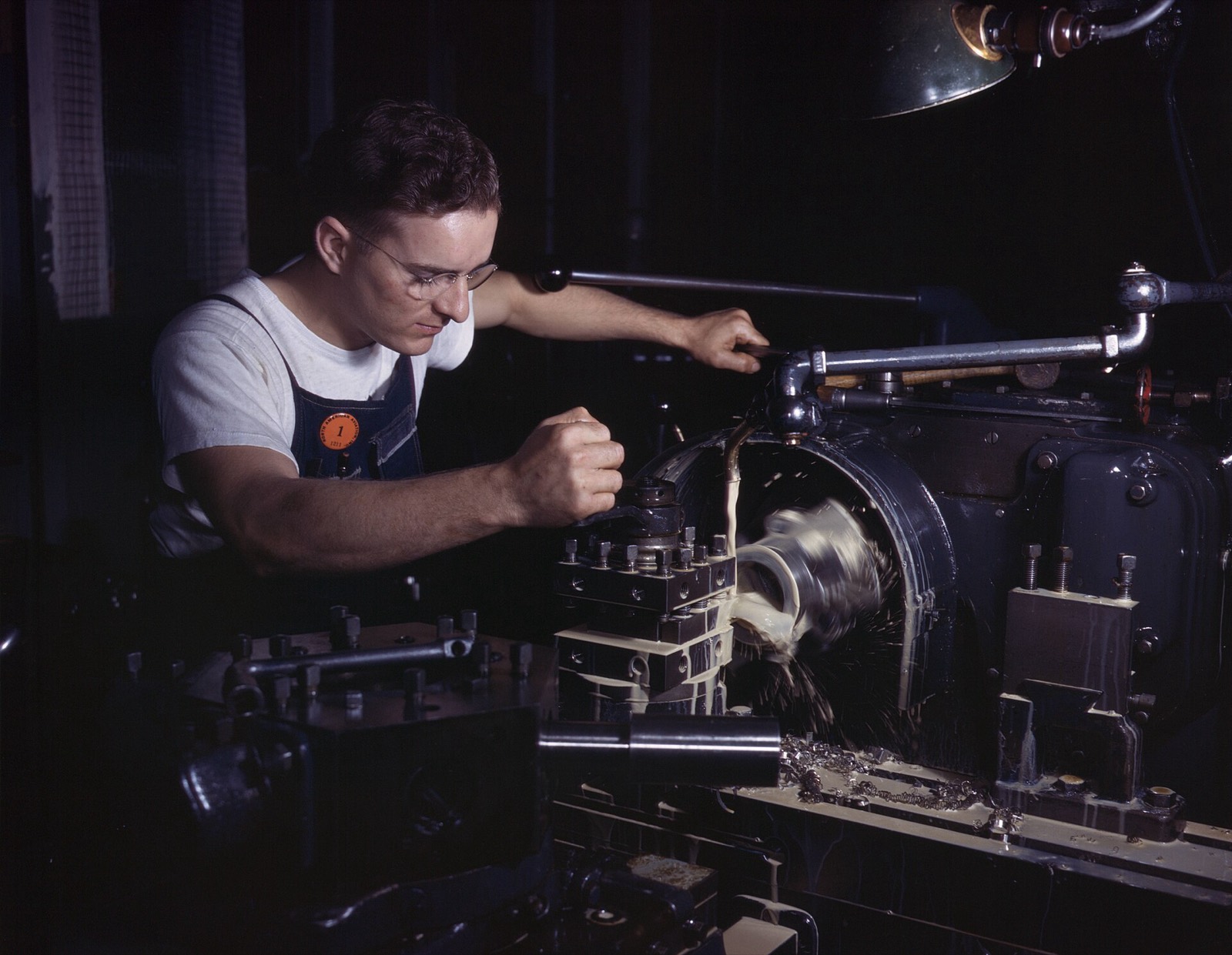 A machinist finishing a part on a turret lathe in 1942